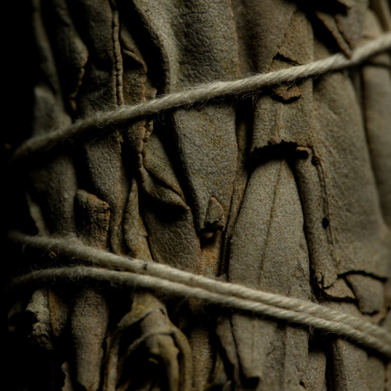 Close-up of textured fabric with twine, dark background