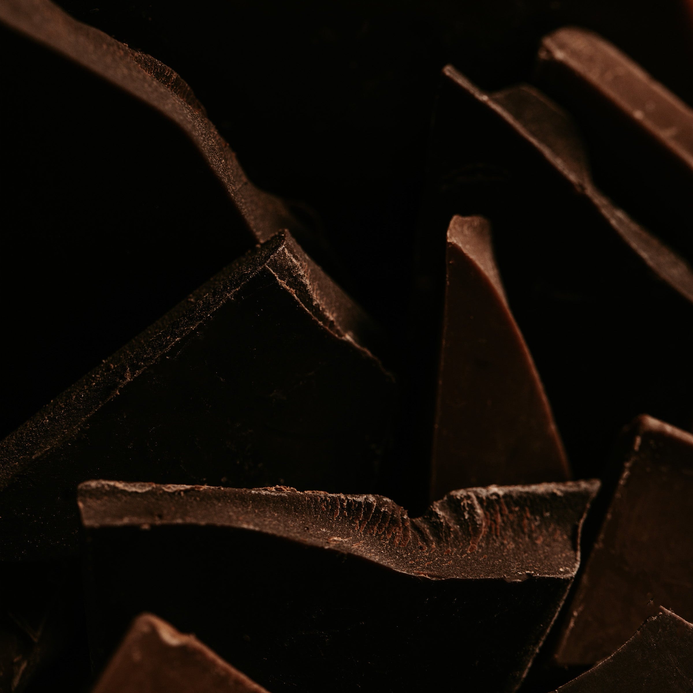 Close-up of dark chocolate pieces on a black background