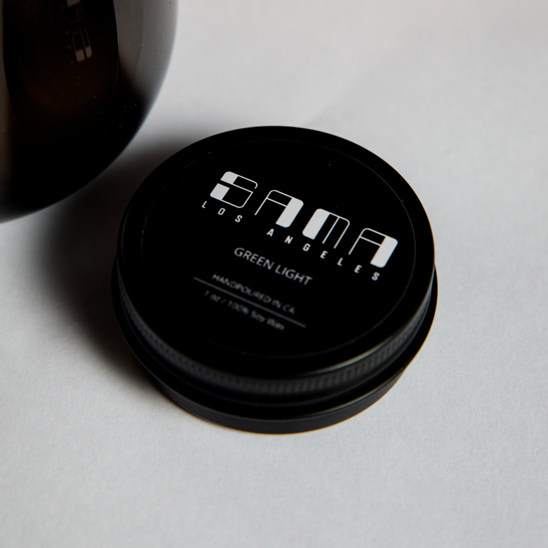 Black container with 'Sama' branding on a light gray surface