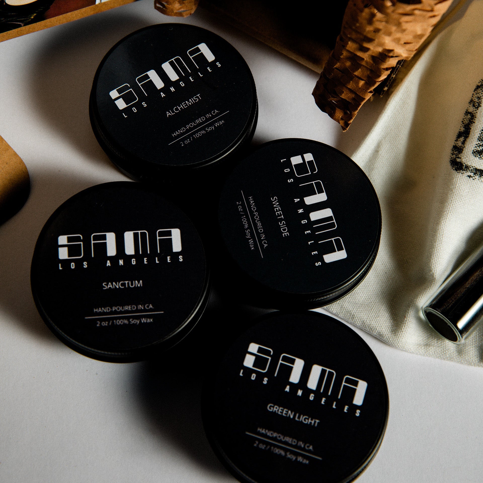 Black containers with 'Sama' branding on a textured surface